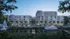 Luxurious waterfront apartment complex at twilight, highlighting modern architecture with palm-lined facade and elegant yachts docked nearby.