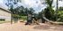 Inviting outdoor playground with slides and climbing structures, nestled in a lush green setting perfect for fun.