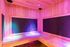 Luxurious infrared sauna with ambient LED lighting, featuring modern wood paneling and a cozy bench.
