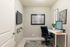 Grove Park Apartments in Tallahassee, FL - Den/ Bonus Room Modern home office with sleek design, featuring a stylish desk setup, artwork, and a wall-mounted TV.