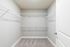 Spacious walk-in closet with sleek wire shelves, perfect for organized storage in a modern apartment.