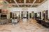 Elegant and spacious lobby featuring luxurious marble flooring, stylish seating areas, and vibrant indoor plants under a stunning wooden ceiling with decorative lighting.