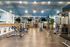 Luxurious fitness center with mirrored walls, modern exercise equipment.