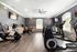 Modern fitness room with sleek exercise bikes, motivational quotes on walls, and ample natural light.