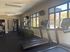 Modern fitness center with state-of-the-art treadmills and elliptical machines, enhanced by large windows offering natural light and vibrant outdoor views.