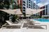 Beautiful poolside area, with stylish loungers, and elegant shades.
