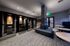 Modern communal area featuring cozy phone booths, stylish seating, and elegant decor, ideal for productive meetings and conducting business.