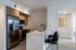 Our modern kitchen design features sleek stainless steel appliances, elegant European cabinetry, and a spacious white countertop with designer faucet.