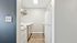 Chic and compact kitchen with white cabinets, modern appliances, and stylish flooring.
