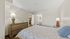 Inviting bedroom with modern decor, soft lighting, and stylish furnishings.