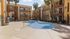 Inviting apartment complex featuring a centrally located swimming pool with surrounding palm trees.