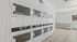 Bright, spacious laundry room featuring multiple modern washing machines in a clean, tiled environment.