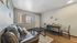 Inviting living room with a comfortable sofa, sleek coffee table, dining area, and bright natural light.