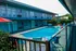 Inviting courtyard pool area surrounded by modern apartments with colorful lounge chairs and umbrellas.
