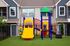 playground equipment in turfed area in front of building.