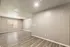Bright, modern living space with sleek wood flooring and fresh neutral walls, perfect for personalized decor.