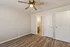 Bright and airy bedroom with a modern ceiling fan, elegant wood flooring, and convenient en-suite bathroom access.