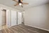 Bright and welcoming room featuring elegant wood flooring, pristine white doors, and a charming ceiling fan.