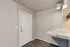 Inviting entryway featuring a sleek granite counter and modern laminate flooring, perfect for contemporary living.