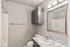 Modern bathroom with elegant granite countertop, sleek gray cabinetry, and contemporary lighting.