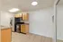 Chic and modern kitchen area with stainless steel appliances and warm wooden cabinetry, offering a sleek and inviting living space.