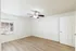 Bright bedroom with hardwood floors, large window, and modern ceiling fan offering a cozy and airy atmosphere.