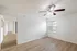 Bright modern room with wooden flooring, a ceiling fan, and sunlit windows, perfect for a comfortable living space.