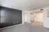 Bright, modern living space with a stylish gray accent wall and plush carpeting, ideal for a chic urban retreat.
