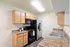 Modern kitchen with elegant wooden cabinetry, sleek appliances, and a spacious dual-sink counter.