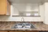 Inviting kitchen view with a modern double sink, elegant granite countertops, and warm wood cabinetry.