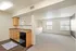 Bright and airy open-plan kitchen with modern countertops and connected living space, featuring large windows and elegant flooring.