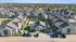Vibrant aerial view of a contemporary apartment complex showcasing spacious courtyards, a refreshing pool, and lush greenery, offering a welcoming and serene community living experience.