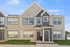 Charming modern townhouse exterior featuring stylish gray and taupe siding, large windows, and elegant gables against a bright blue sky.