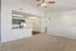 Bright open-concept apartment with modern kitchen, stainless steel appliances, and cozy living space.