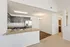 Modern open-concept kitchen with granite countertops, stainless steel appliances, and elegant lighting.
