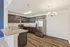 Modern kitchen with sleek stainless steel appliances, dark wood cabinetry, and elegant granite countertops.