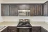 Modern kitchen with elegant dark wood cabinets, stainless steel appliances, and sleek granite countertops.