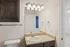 Elegant bathroom with a granite countertop, stylish lighting, and modern fixtures.
