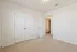 Bright and inviting room with plush carpet and stylish white double doors, great for a cozy bedroom or home office.