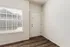 Inviting apartment entrance with modern blinds and warm wood flooring, offering a bright and welcoming atmosphere.