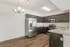 Modern kitchen with sleek dark wood cabinets, stainless steel appliances, and elegant granite countertops.