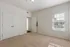 Bright, spacious bedroom with plush carpet, modern double door closet, and large window offering natural sunlight.