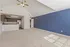 Bright, spacious living area with vaulted ceilings, open-concept kitchen, and a striking blue accent wall.