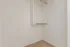 Spacious, well-lit walk-in closet with elegant shelving and ample storage space.
