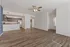Bright, open-concept living space with modern kitchen featuring sleek appliances and elegant wood flooring.