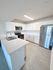 Modern kitchen featuring sleek stainless steel appliances, elegant white cabinetry, and a spacious island with stylish countertops.