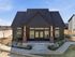 Charming modern home with stylish architecture, elegant brick accents, and inviting landscaped entrance.