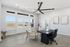Bright and inviting office space with modern seating and sleek desk, showcasing large windows and stylish decor.