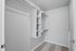 Spacious walk-in closet with ample shelving and hanging space, perfect for organized living.