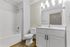 Bright modern bathroom with sleek fixtures, spacious vanity, and elegant lighting.